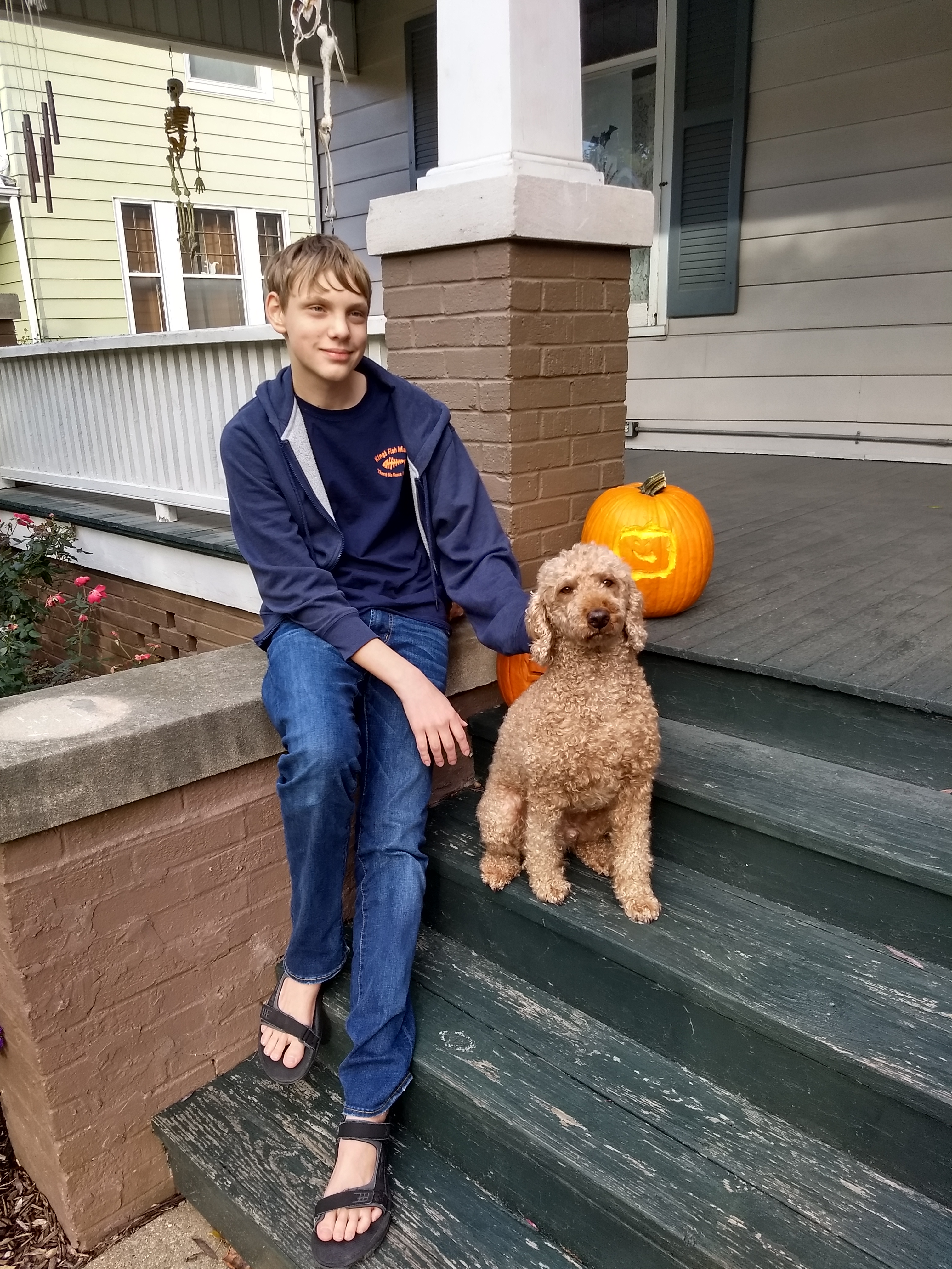 Child and dog with jack-o'lantern