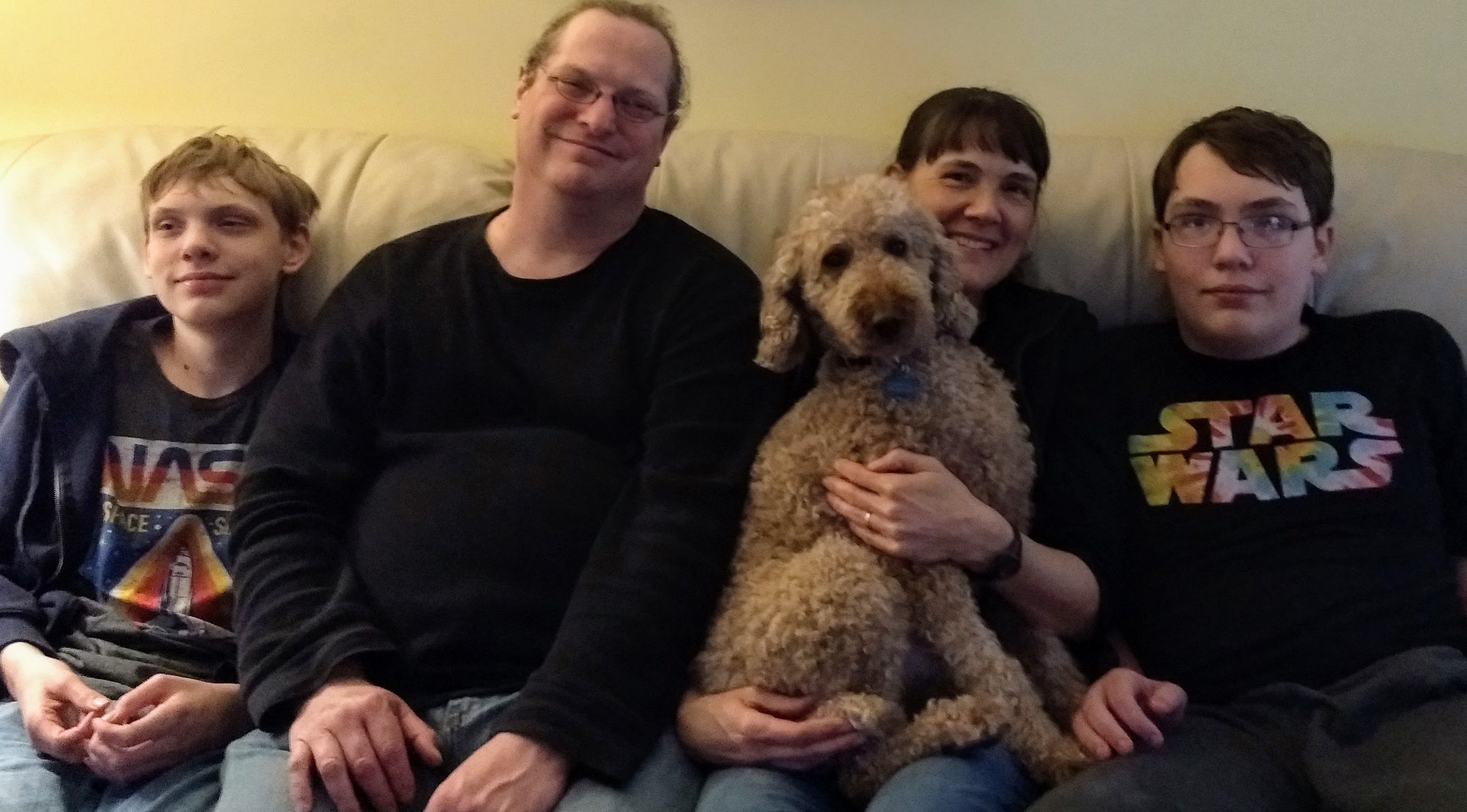 Family on couch with dog