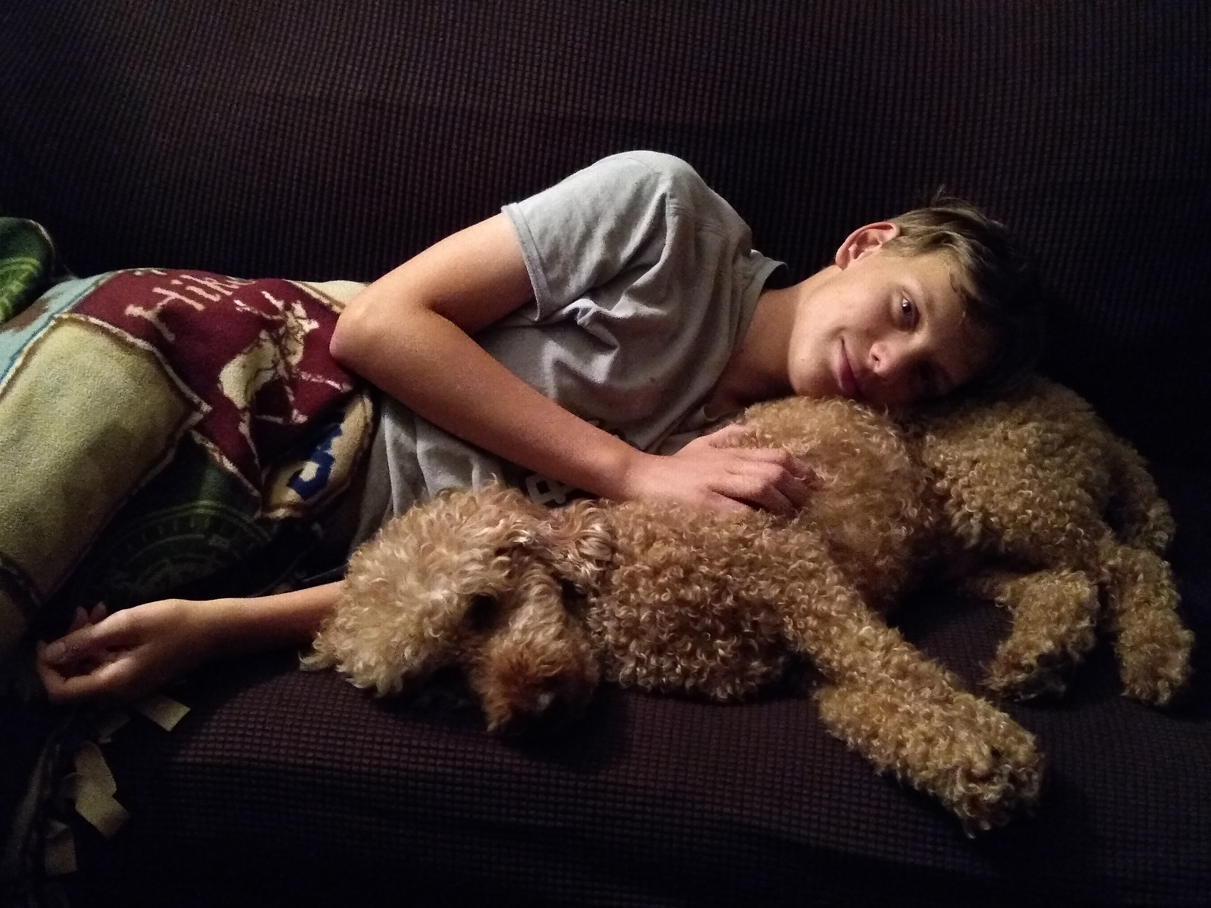 Kid sleeping on dog